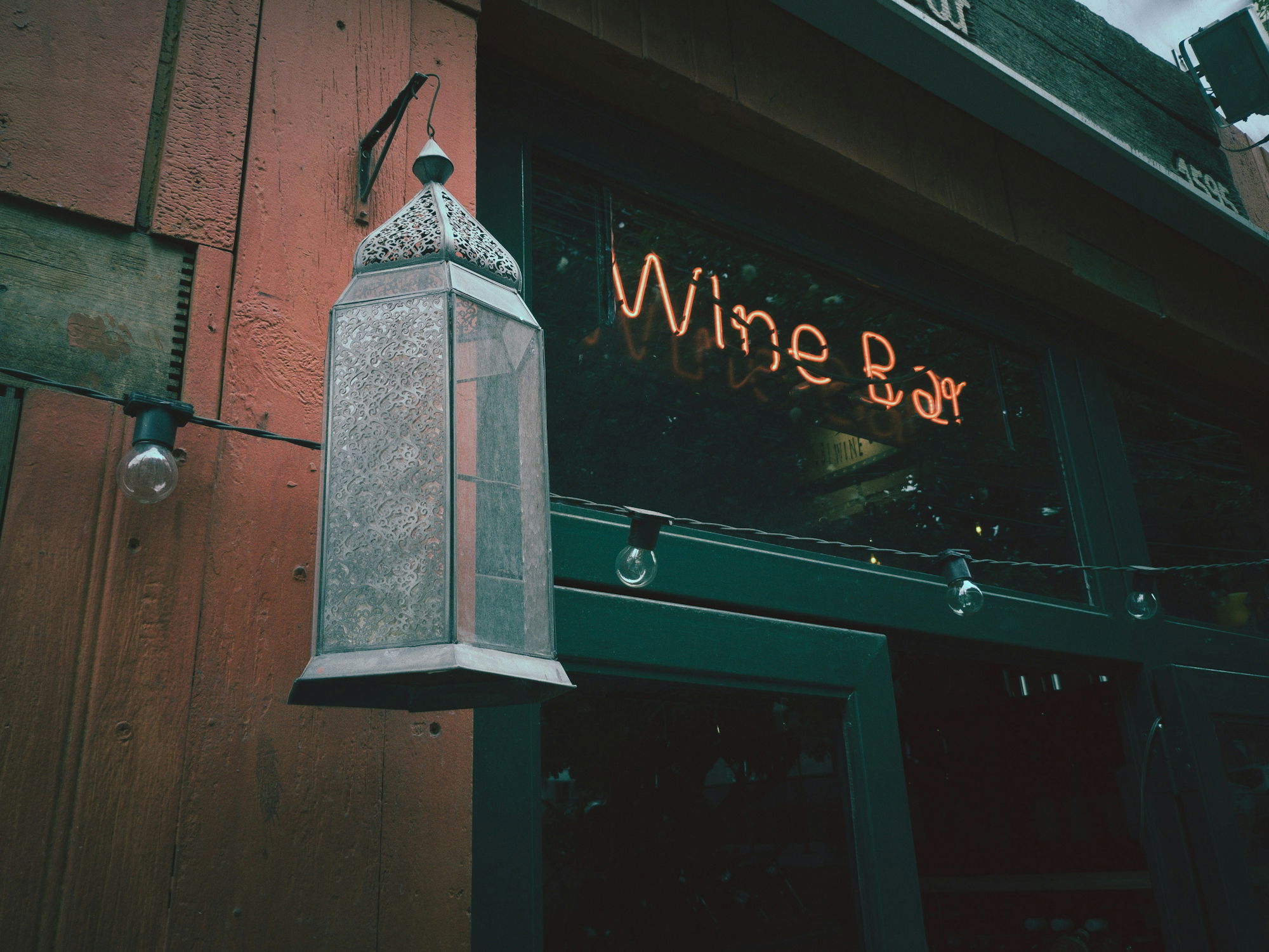 lighted wine bar signage during daytime